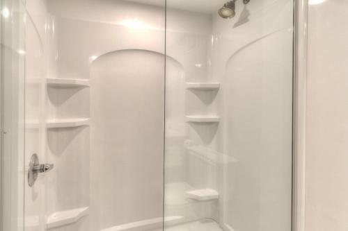 a shower with white shelves in a bathroom at The Ramsey Hotel and Convention Center in Pigeon Forge