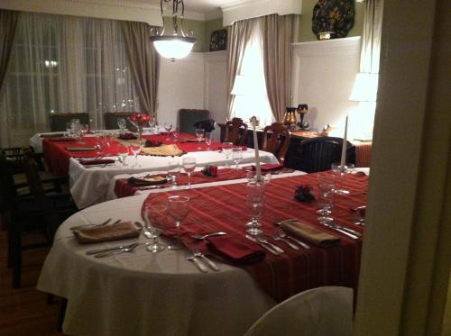 a group of tables with red and white table cloths at Victoria Inn in Hampton