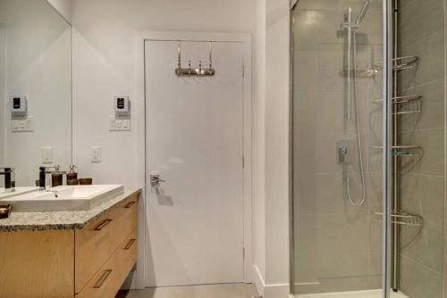 ein Bad mit einer Dusche und einem Waschbecken in der Unterkunft Les Immeubles Charlevoix - 760-307 in Québec