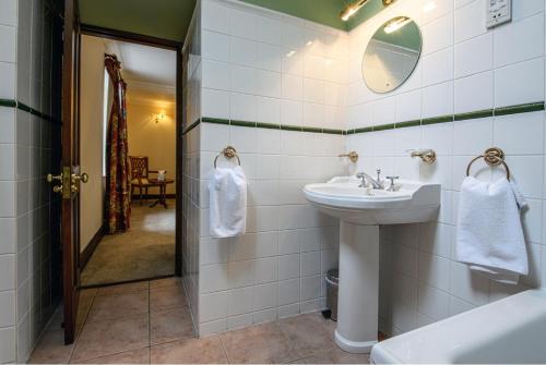 a bathroom with a sink and a mirror at The Bridge Helmsdale in Helmsdale