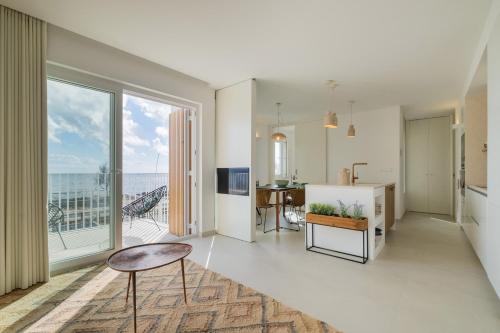 a living room with a view of the ocean at Casa dos Pedros (Beach House) in São Roque
