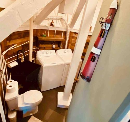a bathroom with a toilet and a missile on the wall at A Magical Treehouse by the Sea! in Hilton Head Island