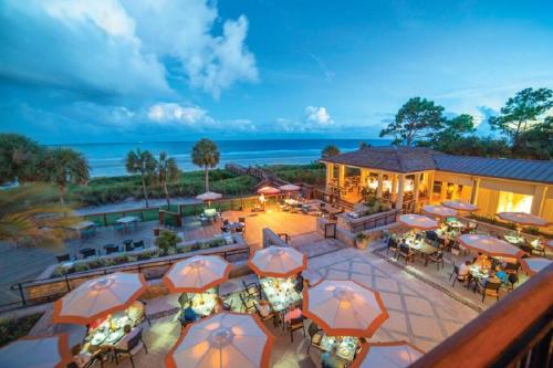 an aerial view of a resort with tables and umbrellas at A Magical Treehouse by the Sea! in Hilton Head Island