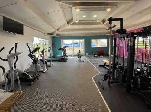 a gym with several treadmills and exercise bikes at Les sables du midi in Valras-Plage
