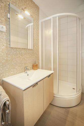 a bathroom with a sink and a shower at Apartments Juranic I in Baška