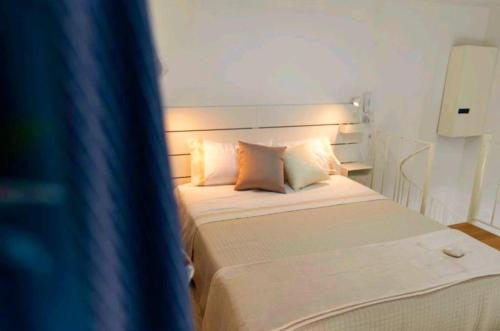 a bedroom with a bed with white sheets and pillows at SANT'ANTIDA APARTMENT in Caserta
