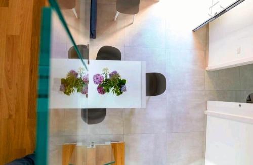 a display of flowers on a wall in a bathroom at SANT'ANTIDA APARTMENT in Caserta