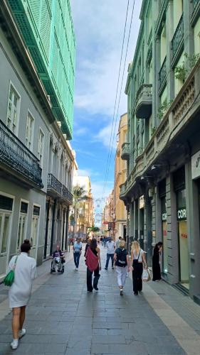 a group of people walking down a city street at NEW CENTRAL LOFT- El verodal de Sabino in Santa Cruz de Tenerife