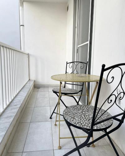 a table and two chairs on a balcony at Stylish 1 bedroom apartment in central Msida C11A in Msida