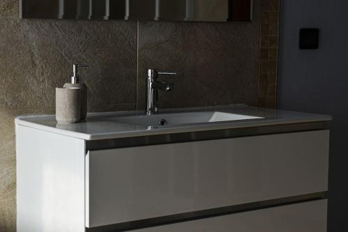 a bathroom sink with a roll of toilet paper on it at Beinalot Country House in Bene Vagienna