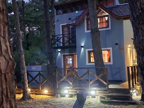a house in the middle of a forest at night at Sueños de Mar in Mar Azul