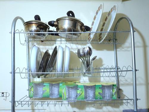 a rack with dishes and utensils in a kitchen at Special Room in downtown Cairo in Cairo