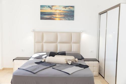 a bedroom with a bed with a picture on the wall at Villa Ella in Stari Bar