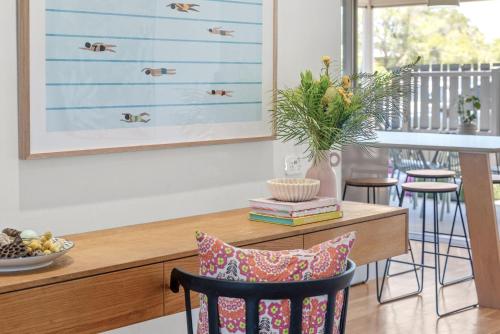 a dining room with a wooden table and chairs at Paperbark in Evans Head