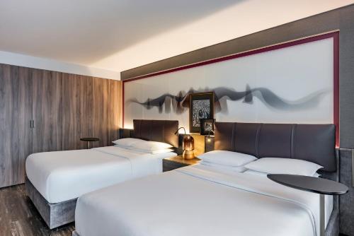 two beds in a hotel room with two beds sidx sidx sidx at Andaz Condesa Mexico City, By Hyatt in Mexico City