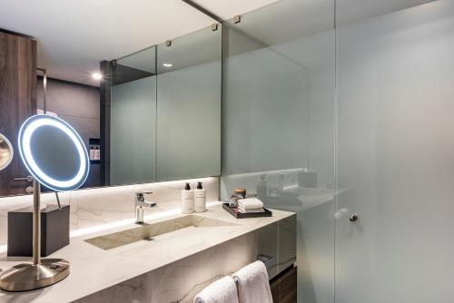a bathroom with a sink and a mirror at Andaz Condesa Mexico City, By Hyatt in Mexico City