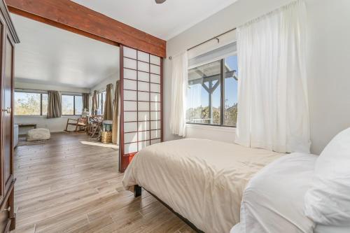 a bedroom with a bed and a large window at Close to JT Park & Town w/360 View The Green Adobe in Joshua Tree