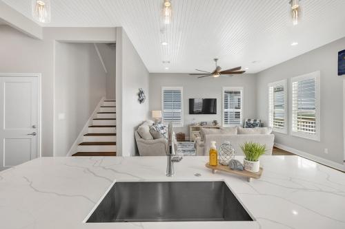 a kitchen with a sink and a living room at Fishermans Delight home in Port Bolivar