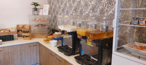 a kitchen with a coffee maker on a counter at Nightelier Devonport Gateway Hotel in Devonport