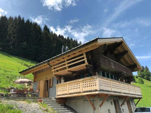 a building with a balcony on the side of it at Boutique Chalet Panoramic Views Hot Tub in Vers L'Eglise