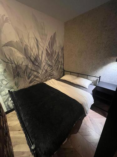a bedroom with a bed with a flower mural on the wall at Luksusowy loft nad jeziorem Swarzędz koło Poznań in Swarzędz