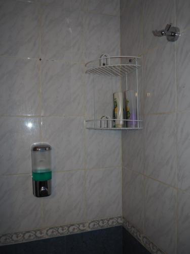 un dispenser di sapone sulla parete di una doccia di QONDADO a Ushuaia