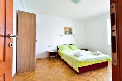 a bedroom with a bed and a wooden floor at Dream Beloc House Lopud Island in Lopud