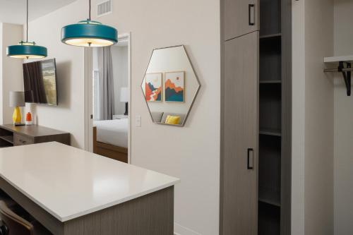 a kitchen with a white counter and a mirror at WaterWalk Boise-Meridian in Meridian