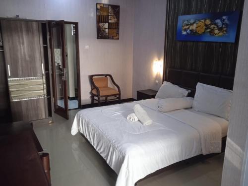 a hotel room with a bed with two towels on it at NEW KUBU DI BUKIT in Jimbaran