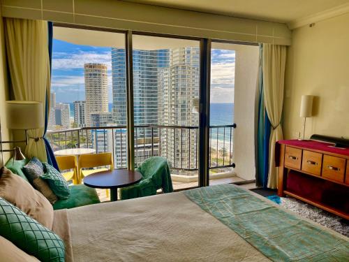 a bedroom with a bed and a view of the ocean at High Floor Ocean View at Surfers Paradise - Hotel Studio in Gold Coast