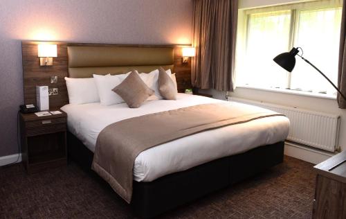 a bedroom with a large bed and a window at Holiday Inn Telford Ironbridge by IHG in Telford