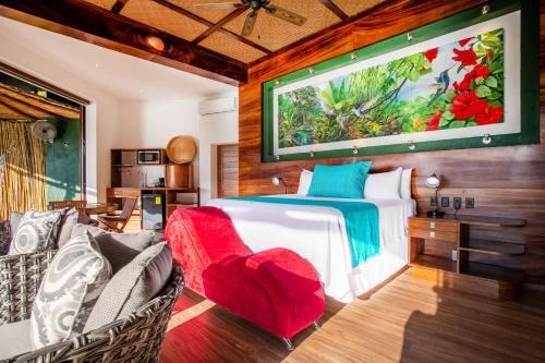 a bedroom with a bed with a large painting on the wall at Villa Lala Boutique Hotel Adults Only in Puerto Vallarta