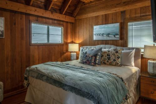 a bedroom with wooden walls and a bed with pillows at 3796 The Madden Suite apts in Carmel