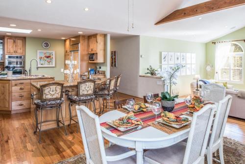 a kitchen and dining room with a table and chairs at 3485 Avalon by the Sea home in Monterey