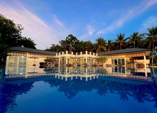 an exterior view of a house with a swimming pool at Blue Joys MSR in Siquijor