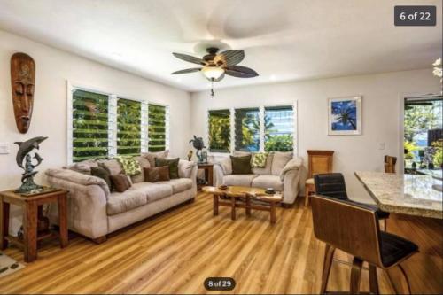 a living room with a couch and a ceiling fan at Beautiful ocean house, walk to MAGIC SAND BEACH in Kailua-Kona