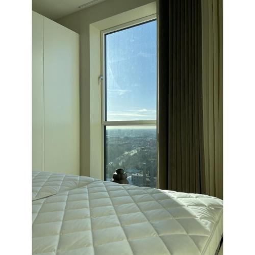 a bedroom with a bed and a large window at ApartmentInCopenhagen Apartment 1525 in Copenhagen