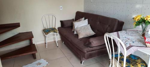 a living room with a brown couch and a table at Loftcharmoso2 in Pinhais