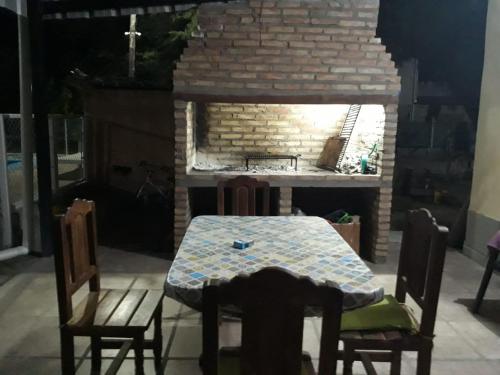a table and chairs in front of a brick oven at EL TALAR 1 in Sauce Bajada