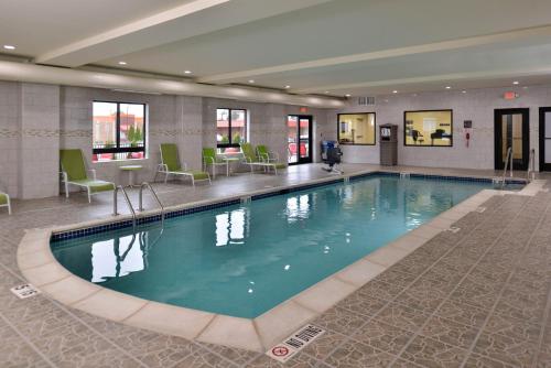 a large swimming pool in a hotel lobby at Holiday Inn Express & Suites Dearborn SW - Detroit Area, an IHG Hotel in Dearborn