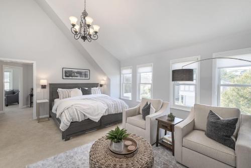 a bedroom with a bed and a couch and a chair at 3813 Point Break home in Pacific Grove