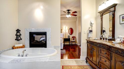 a bathroom with a tub and a sink and a bathroom with at The River Belle Inn in Healdsburg