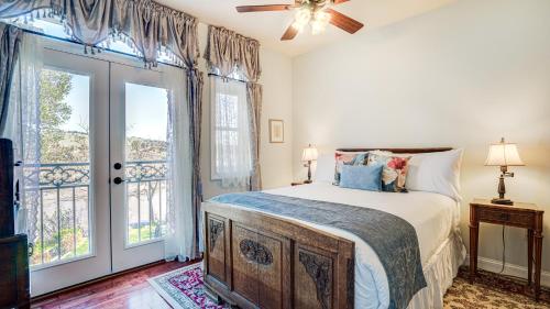 a bedroom with a bed and a large window at The River Belle Inn in Healdsburg