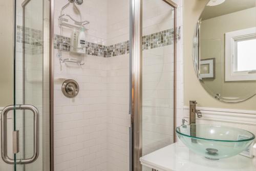 a bathroom with a glass sink and a shower at 3788 The Seagull's Nest home in Pacific Grove
