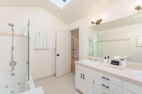 a white bathroom with a shower and a sink at 3867 Dolce Tempo home in Carmel