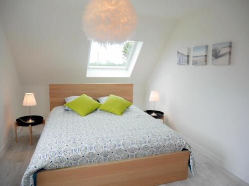 um quarto com uma cama com duas almofadas amarelas em Cottage, St Pabu em Kervasdou
