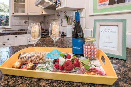 a tray with two wine glasses and a plate of food at 3743 Pelican Peaks home in Pacific Grove