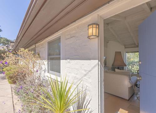 a white house with a couch and a window at 3786 Adobe by the Sea home in Pebble Beach