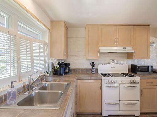 a kitchen with a sink and a stove at 3786 Adobe by the Sea home in Pebble Beach