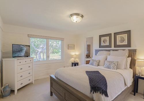 a bedroom with a bed and a television in it at 3786 Adobe by the Sea home in Pebble Beach
